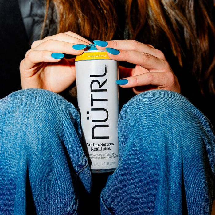 Person holding a Nutrl can